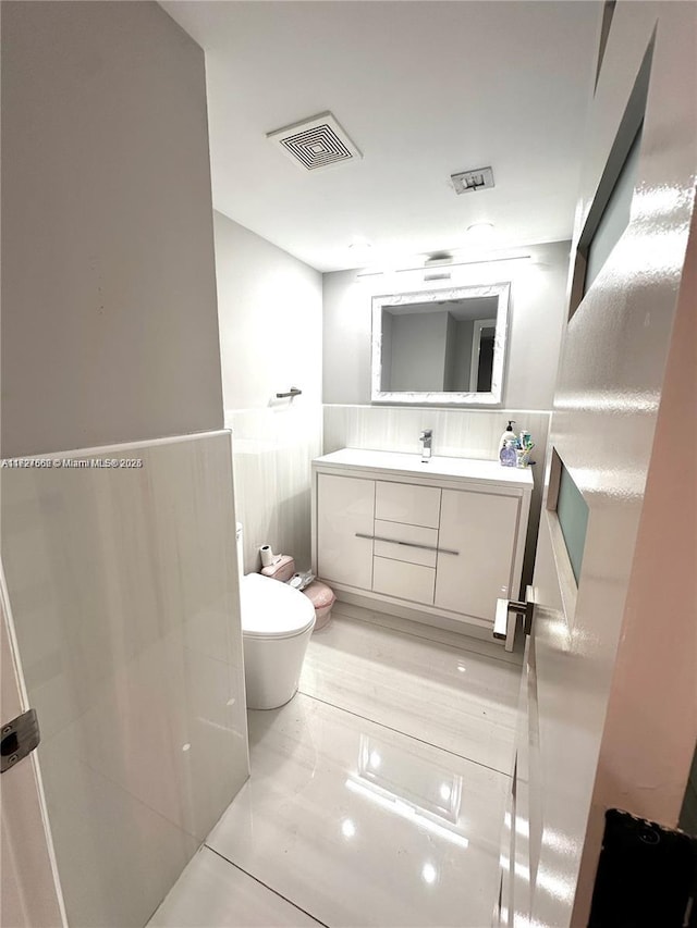 bathroom with toilet and vanity