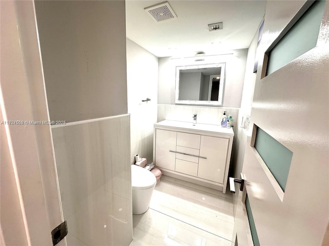 bathroom with toilet and vanity