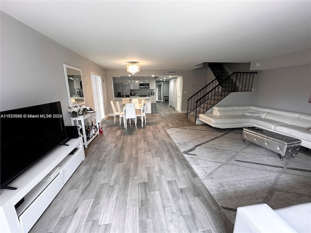 living room featuring a notable chandelier and hardwood / wood-style floors