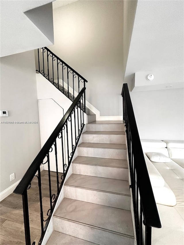 stairway featuring hardwood / wood-style flooring