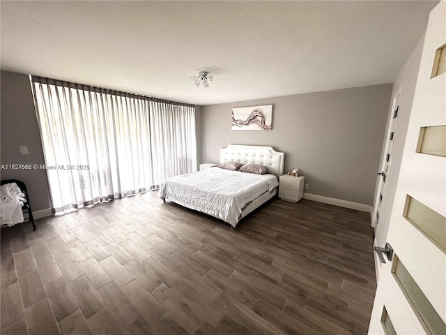 bedroom with dark hardwood / wood-style flooring