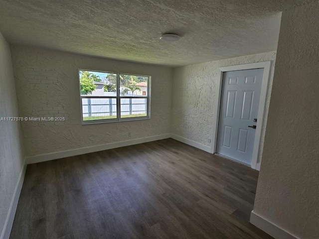 spare room featuring dark wood-type flooring