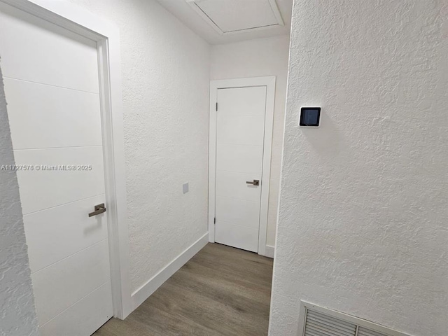 corridor with hardwood / wood-style floors