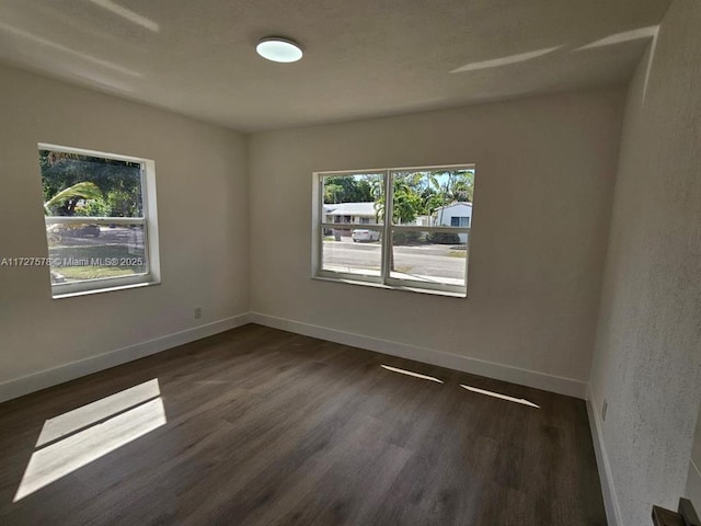 spare room with dark hardwood / wood-style floors