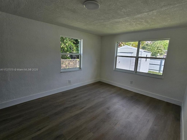 empty room with dark wood-type flooring