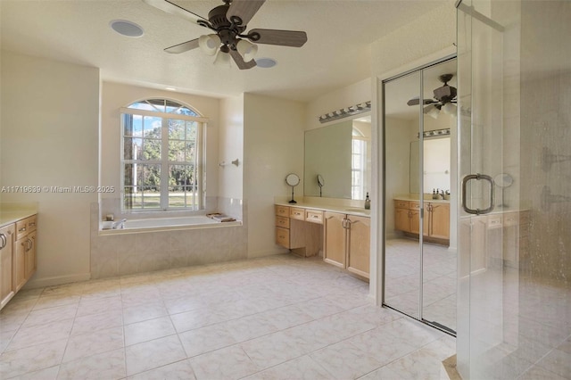 bathroom with ceiling fan, vanity, tile patterned floors, and plus walk in shower