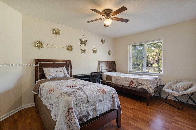 bedroom with ceiling fan and wood-type flooring