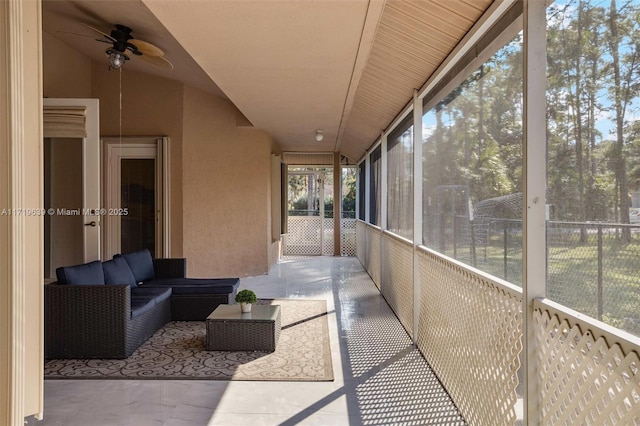 sunroom / solarium featuring ceiling fan