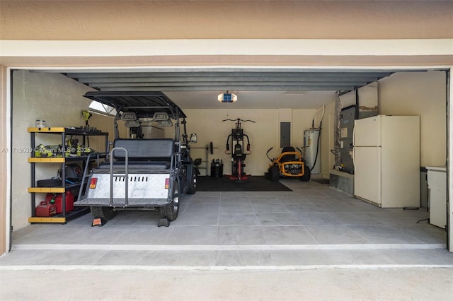 garage featuring water heater, white refrigerator, a garage door opener, electric panel, and heating unit