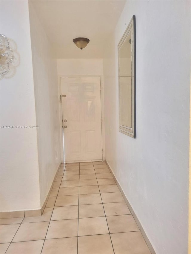 hall featuring light tile patterned floors