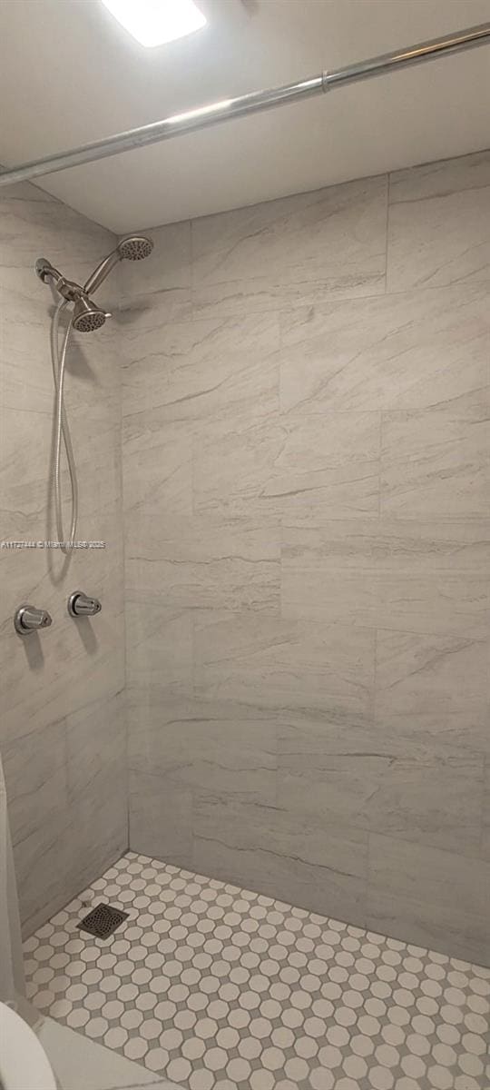 bathroom with tiled shower