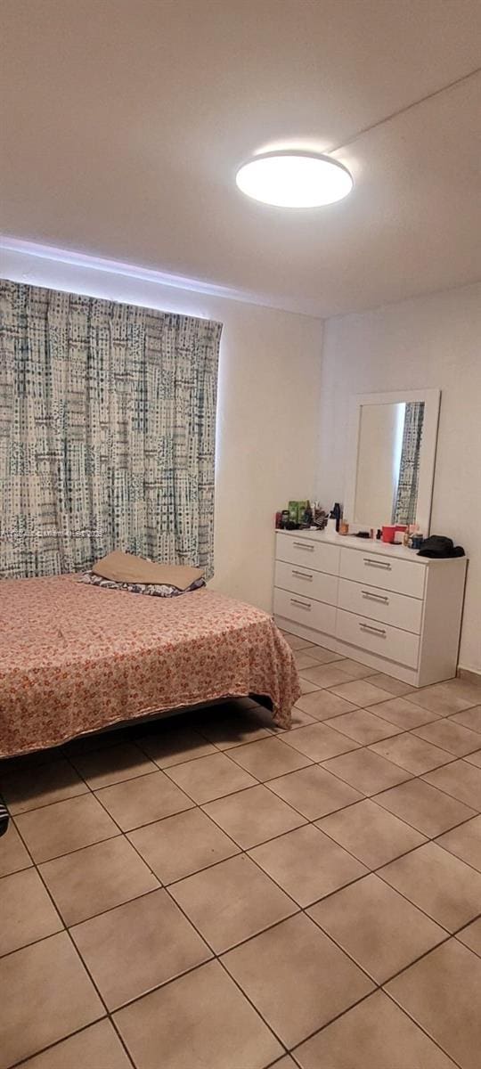 bedroom featuring light tile patterned flooring