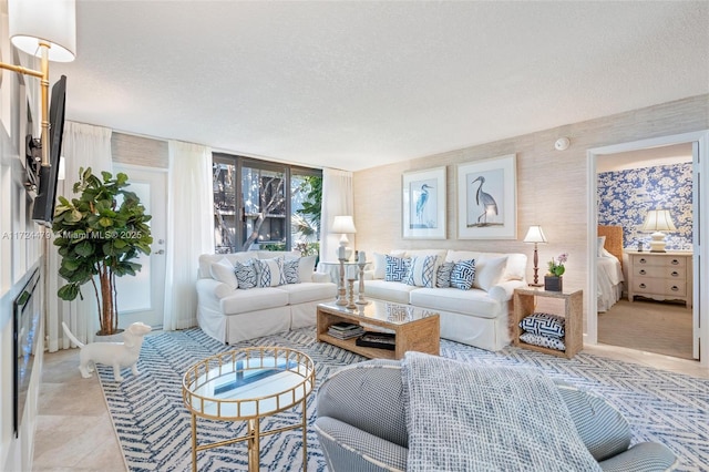 living room with floor to ceiling windows and a textured ceiling