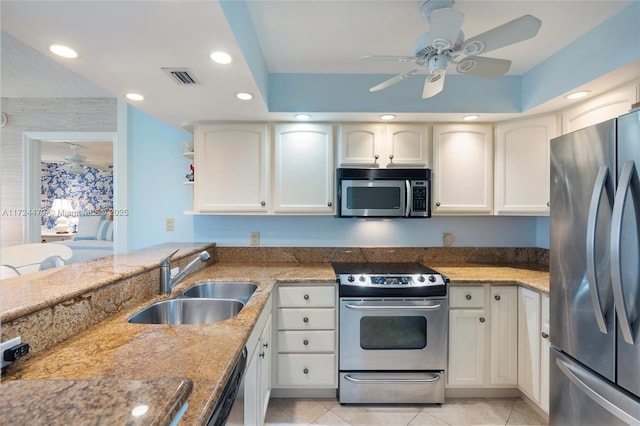 kitchen featuring ceiling fan, stainless steel appliances, light tile patterned flooring, white cabinets, and sink