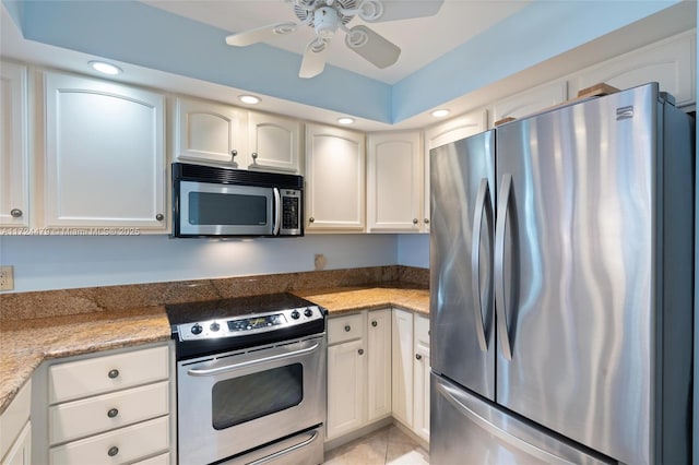 kitchen with white cabinetry, ceiling fan, appliances with stainless steel finishes, light tile patterned flooring, and stone countertops