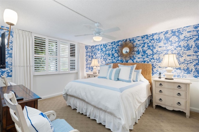 bedroom featuring a textured ceiling, ceiling fan, and light colored carpet