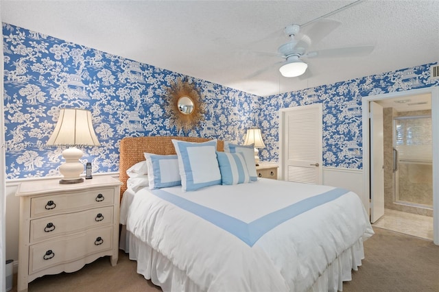 bedroom with ceiling fan, ensuite bath, a closet, and a textured ceiling