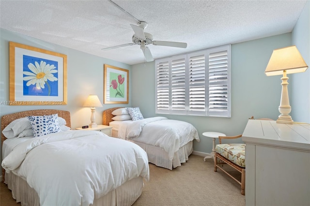 carpeted bedroom featuring ceiling fan and a textured ceiling