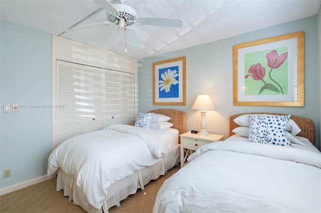 carpeted bedroom with ceiling fan, a closet, and a textured ceiling