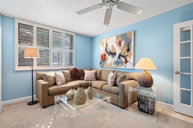 living room with ceiling fan and a textured ceiling