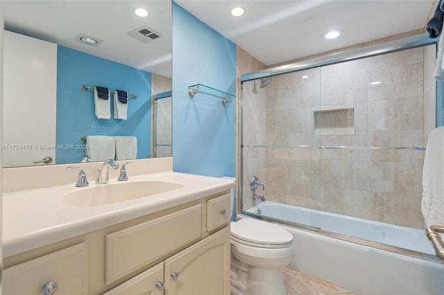 full bathroom featuring enclosed tub / shower combo, vanity, toilet, and tile patterned flooring