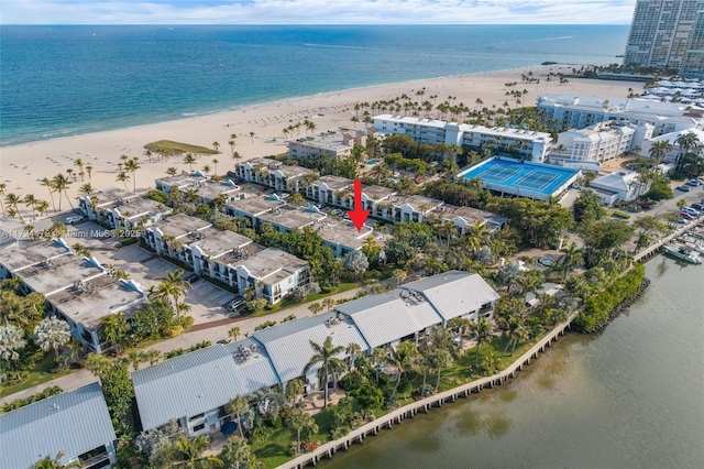 drone / aerial view featuring a water view and a beach view