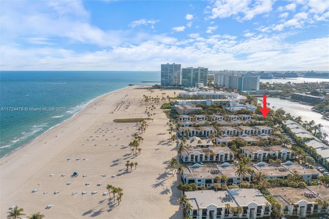 drone / aerial view with a beach view and a water view