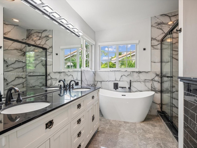 bathroom with plus walk in shower, tile walls, and vanity