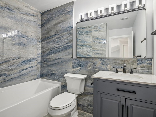 bathroom with toilet, tile walls, tasteful backsplash, and vanity