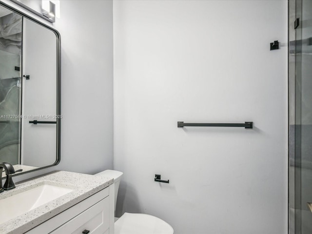 bathroom featuring toilet and vanity