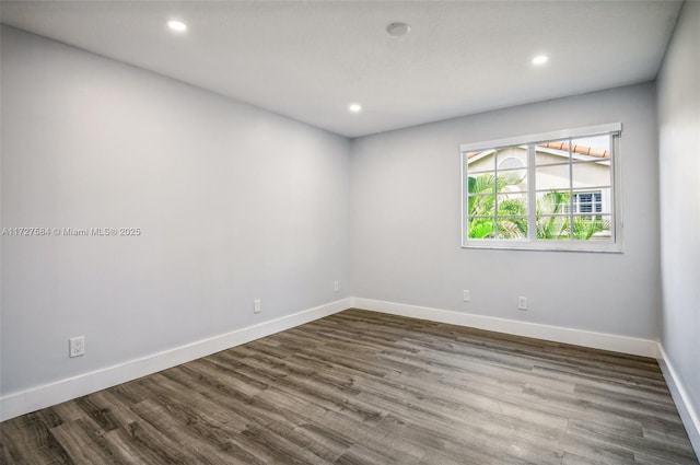 unfurnished room with hardwood / wood-style floors