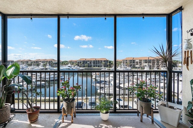 unfurnished sunroom with a water view and a wealth of natural light