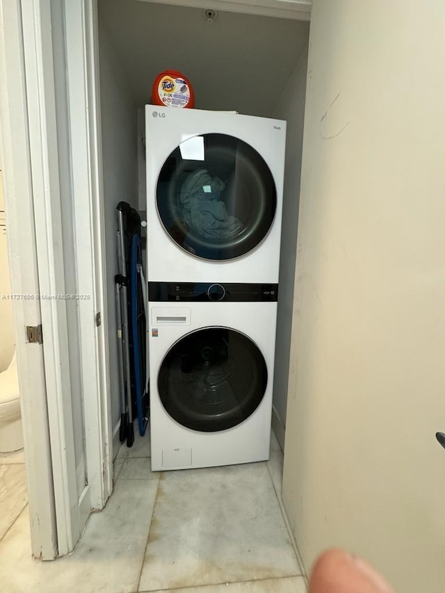 washroom featuring stacked washer / drying machine