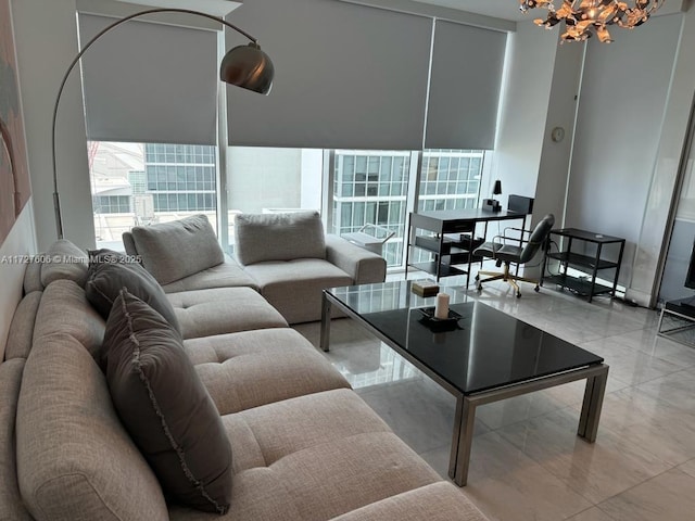 living room featuring a chandelier and plenty of natural light