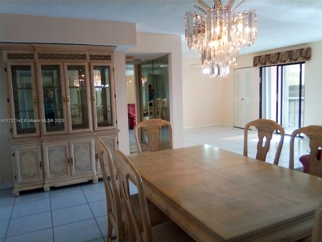 dining area featuring light tile patterned floors and a notable chandelier