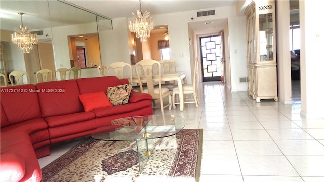 living room with tile patterned flooring and a notable chandelier