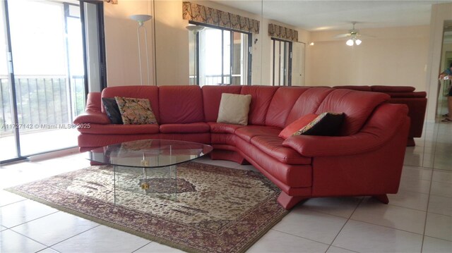 tiled living room featuring ceiling fan