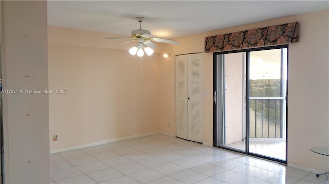 tiled spare room with ceiling fan