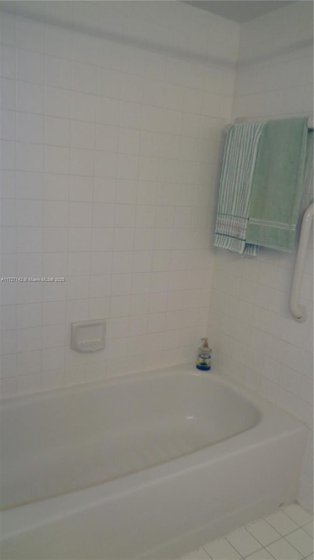 bathroom featuring tile patterned flooring and shower / bath combination