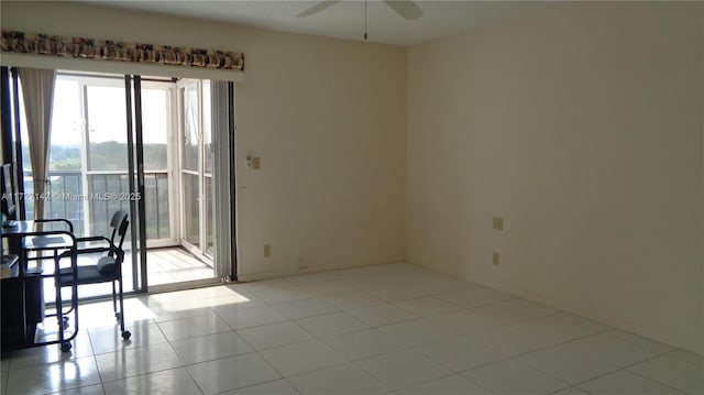 empty room with ceiling fan and light tile patterned flooring