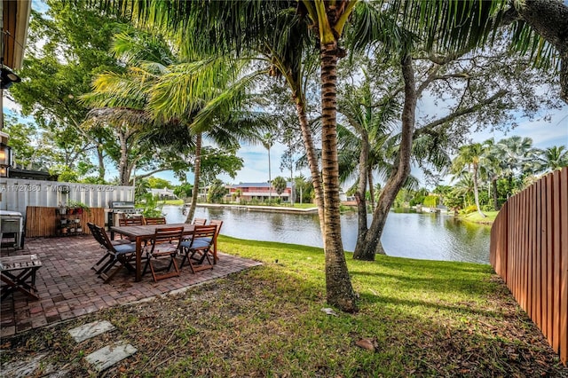 view of yard featuring a water view and a patio