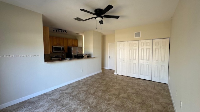 unfurnished bedroom featuring ceiling fan, stainless steel fridge with ice dispenser, and a closet