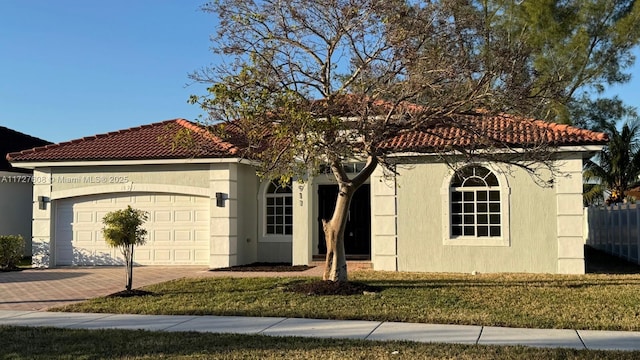 mediterranean / spanish-style home featuring a garage and a front yard