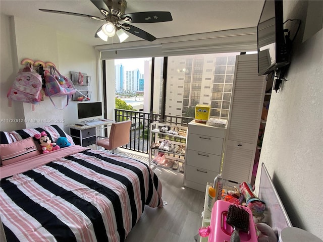 bedroom with hardwood / wood-style flooring and ceiling fan