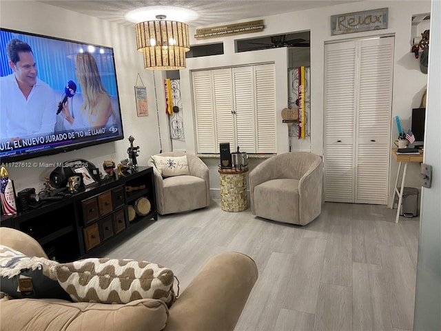 living room featuring an inviting chandelier and light wood-type flooring