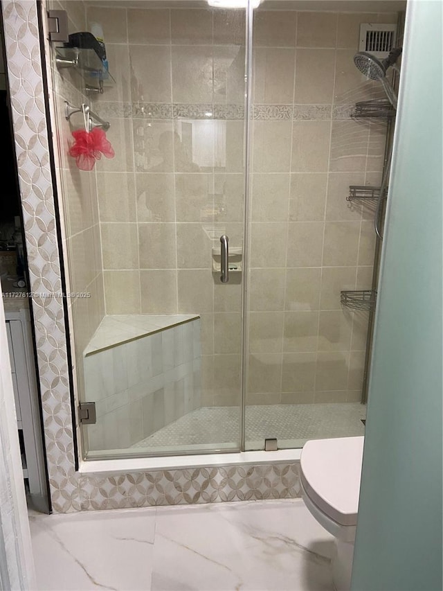 bathroom with walk in shower and toilet