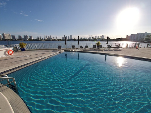 pool with a view of city and a patio