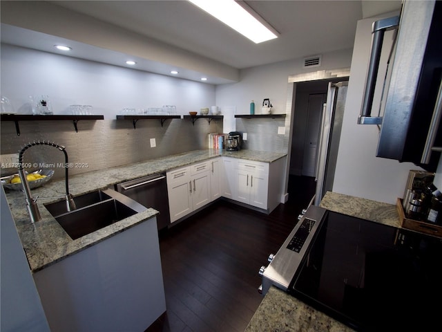 kitchen featuring stainless steel appliances, sink, white cabinets, and light stone counters