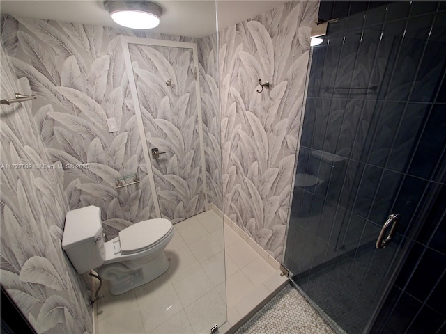 full bath with tile patterned flooring, a shower stall, and toilet