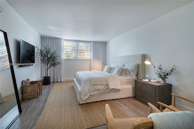 bedroom with hardwood / wood-style floors